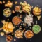 Assorted snacks including chips, nuts, popcorn and crispy treats in bowls